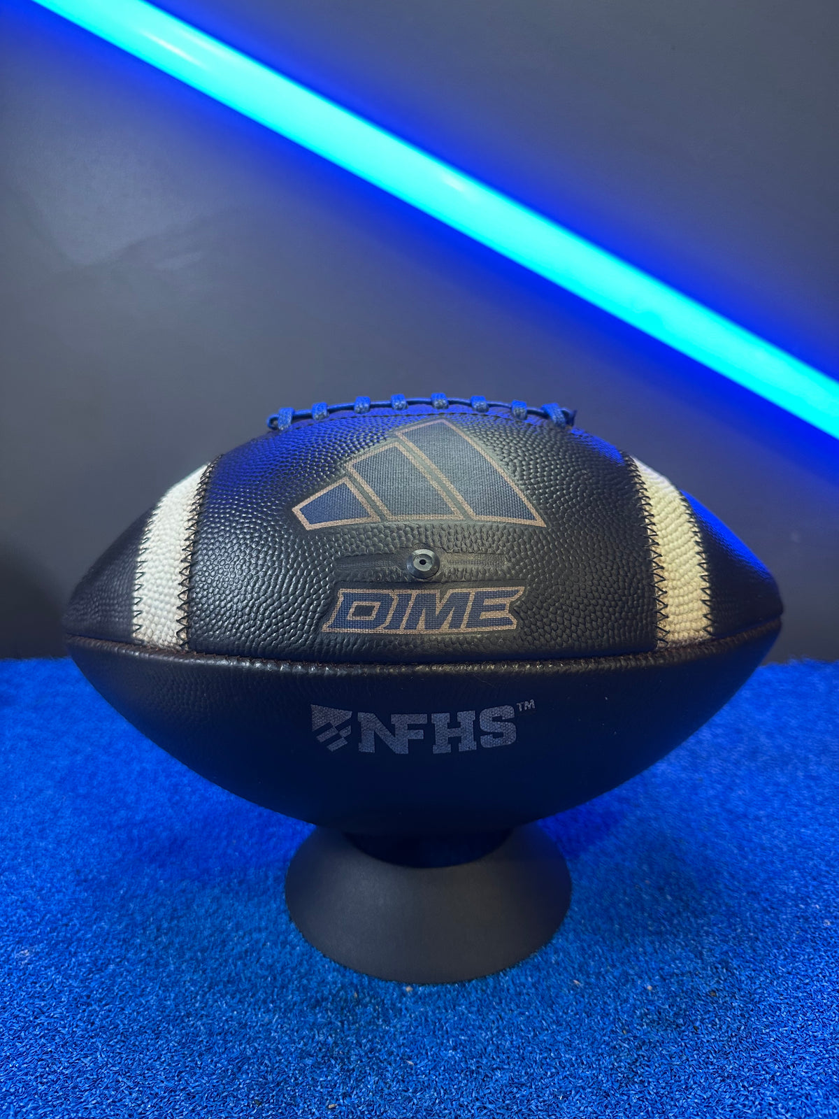 Black and blue football with 'Dime' branding on a blue and black background Mudded and Prepped