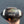 Hand holding a prepped football with 'CFP 2026' branding against a dark background